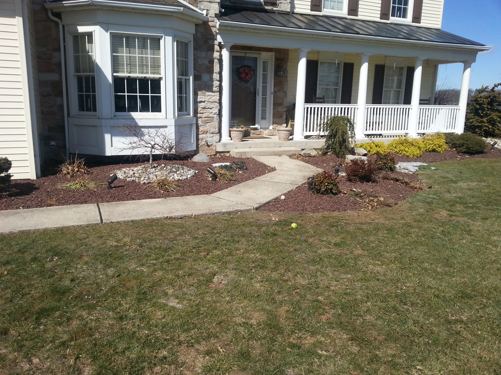before image of a stone walkway of a home near grassy yard